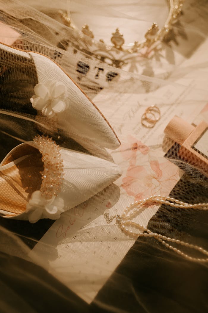 Chic flat lay of bridal shoes, veil, necklace, and headband for wedding inspiration.